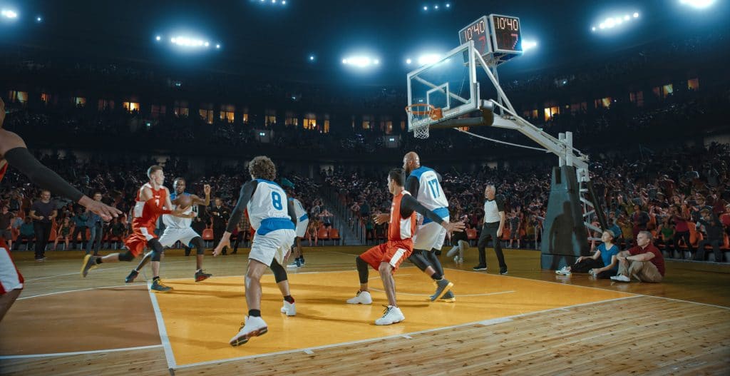 College basketball teams playing on a court during March Madness