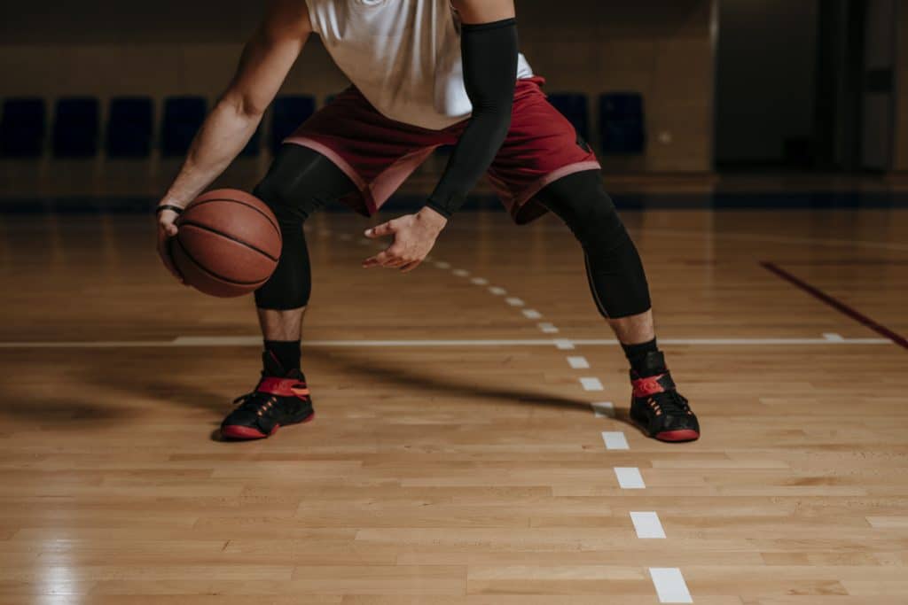 College basketball player dribbling ball