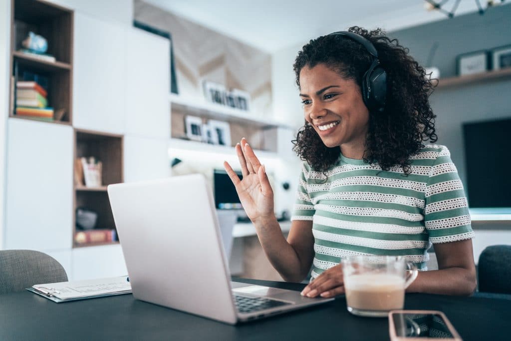 Woman participating in a video conference in her home office