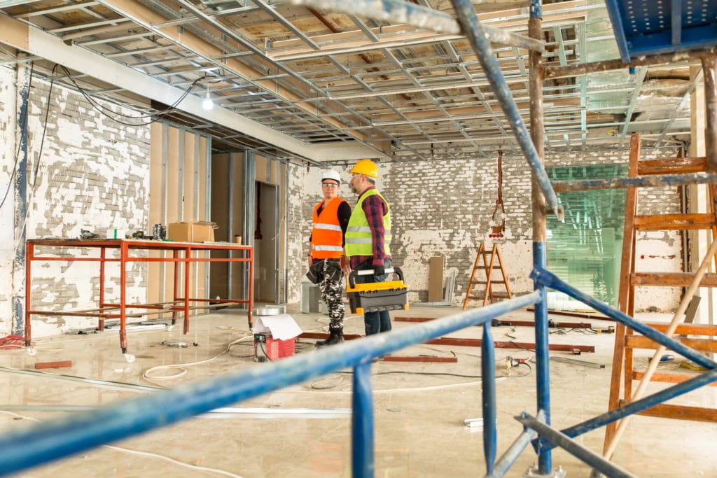 Two construction workers preparing to depart a construction site