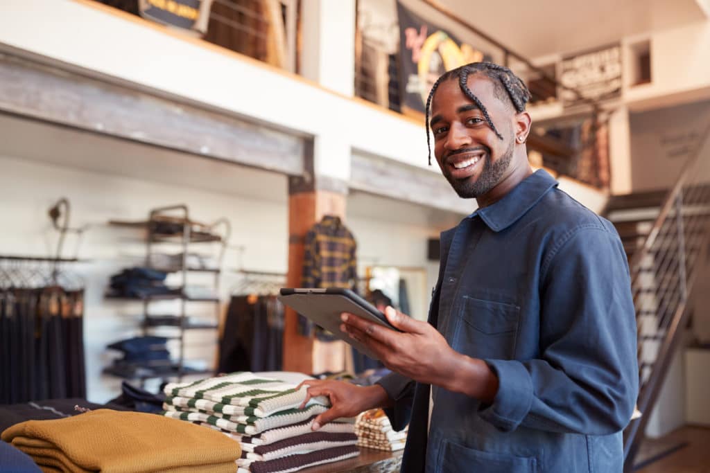 A store employee reviewing merchandise on display