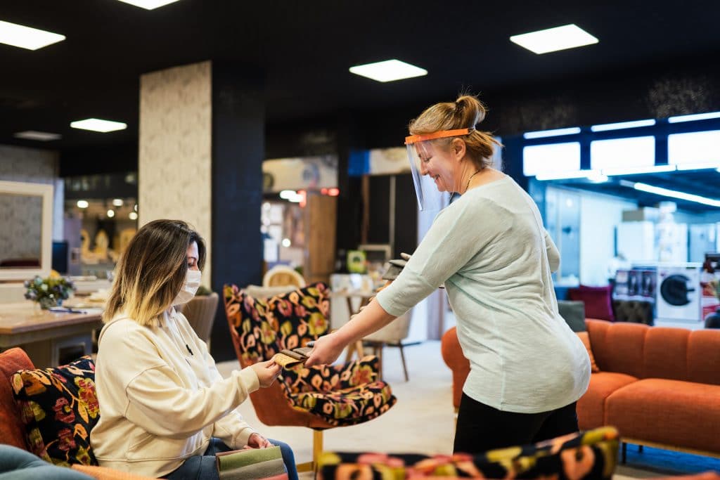 A customer and store associate interacting in a retail merchandising area