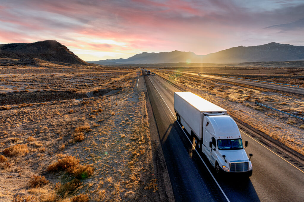 Semi truck alone on a desert road potentially hauling supply for last mile delivery