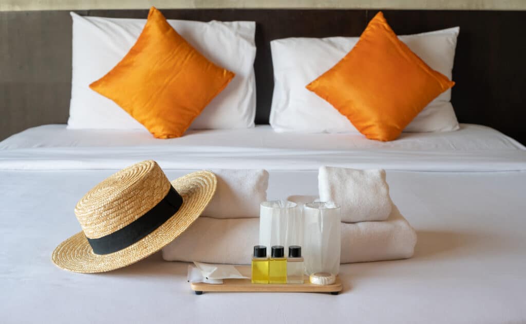 A bed with towels and toiletries on it at a pop-up hotel