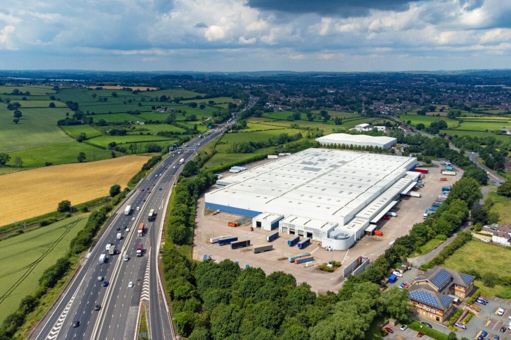 Aerial view of a trucking hub next to a highway