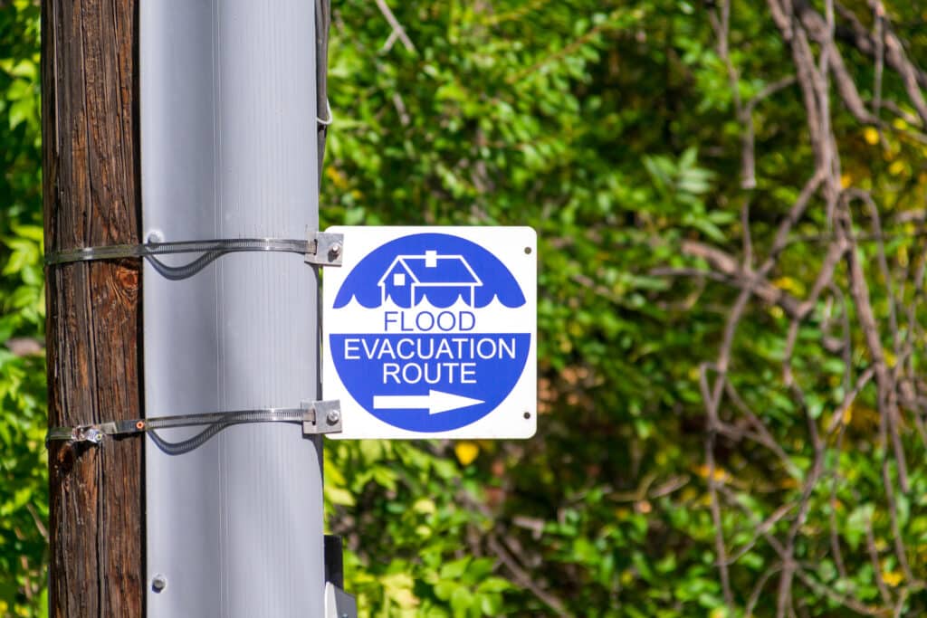 Sign indicating a flood evacuation route at the side of a road