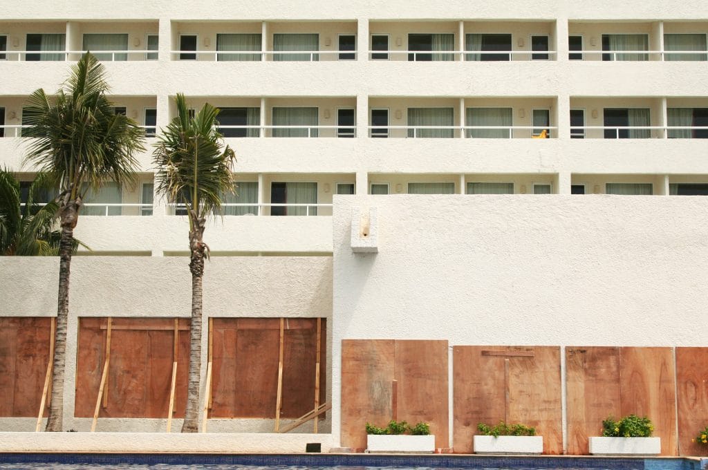 Exterior windows of a hotel in the South with boarded up windows