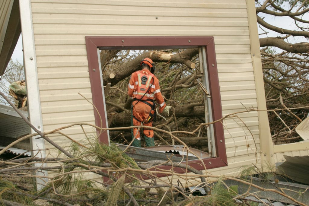 Firefighter walking around a damaged building
