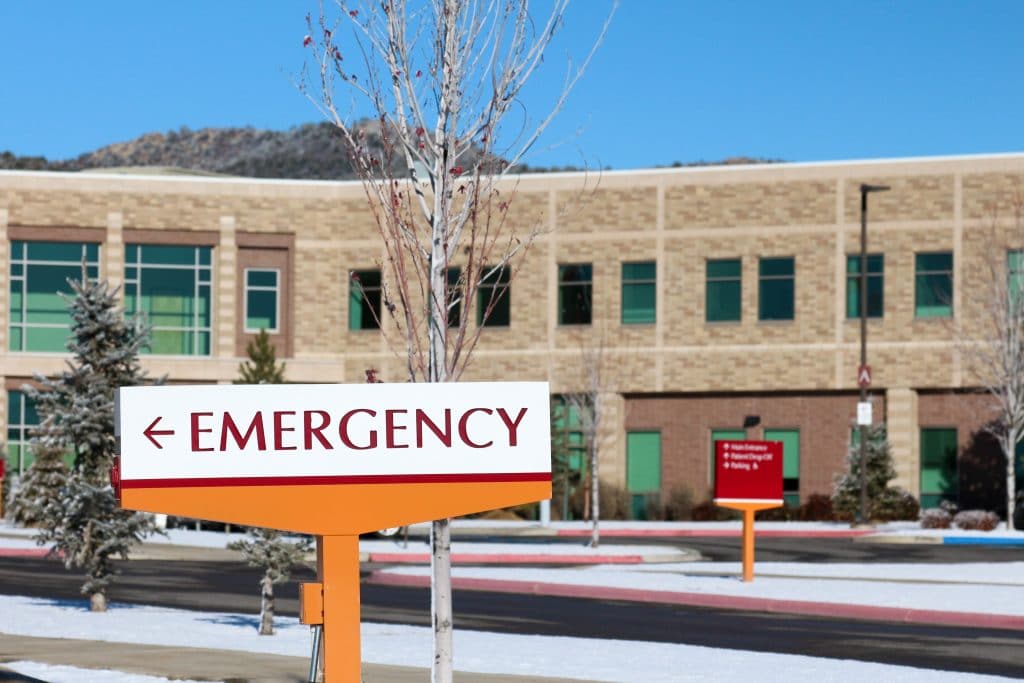 An emergency sign in front of a hospital in the winter