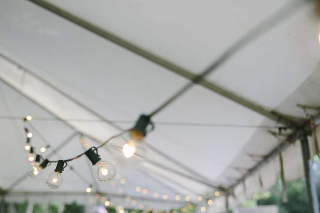 A strong of lights hanging inside a tent