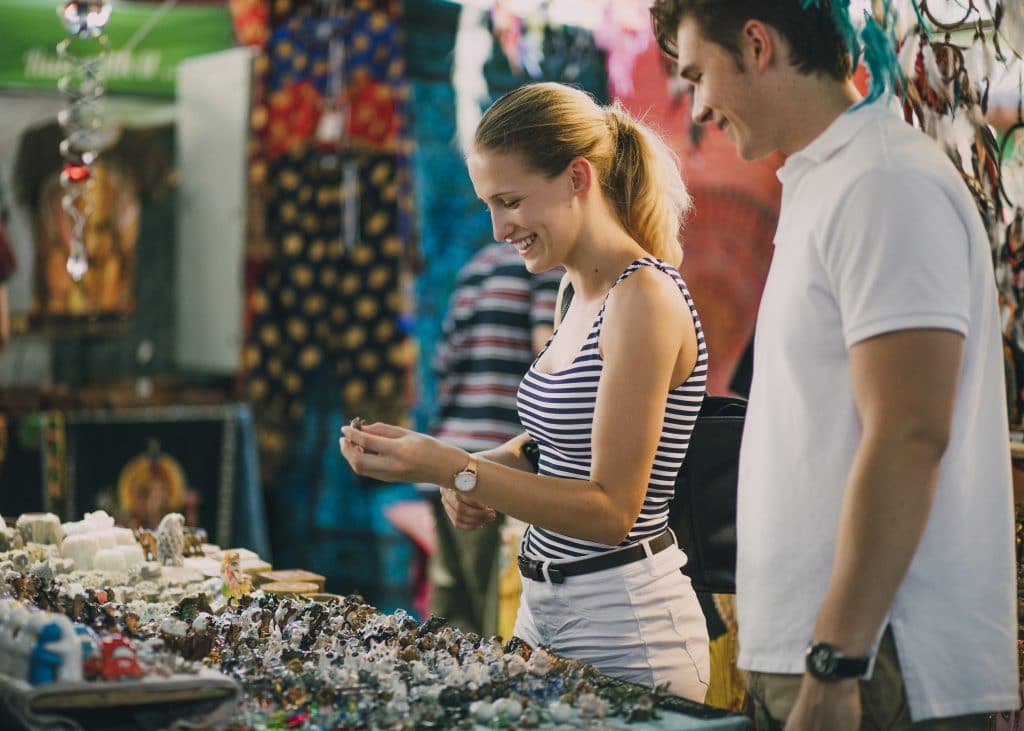 A man and woman browsing jewelry at a pop-up store