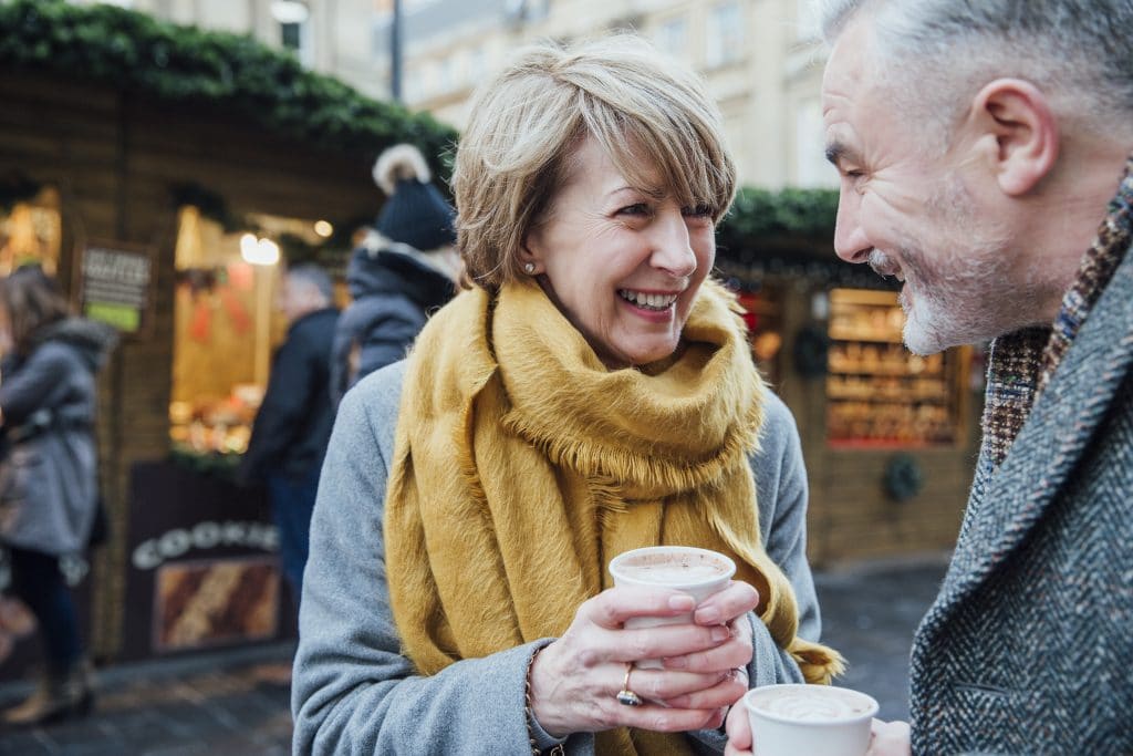 A couple enjoying coffee they purchased at a pop-up restaurant