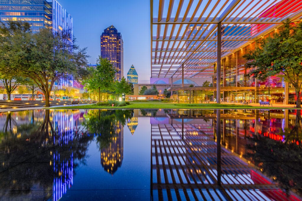 Scene of downtown Dallas at night reflecting on a body of water