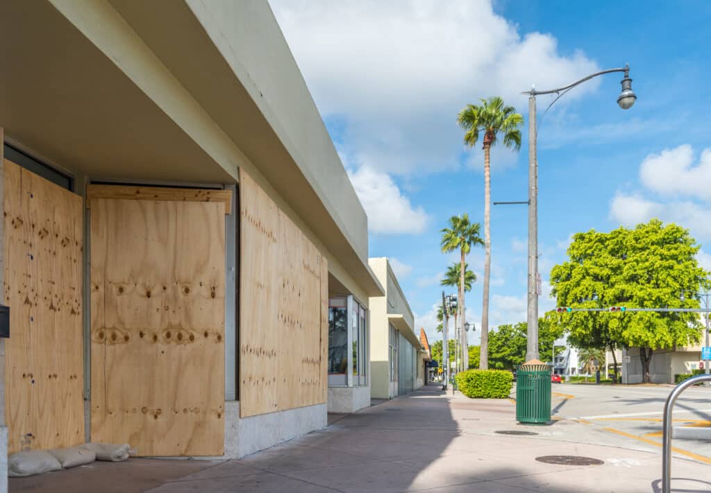 Shops in a tropical city boarded up for hurricane or flood disaster preparedness