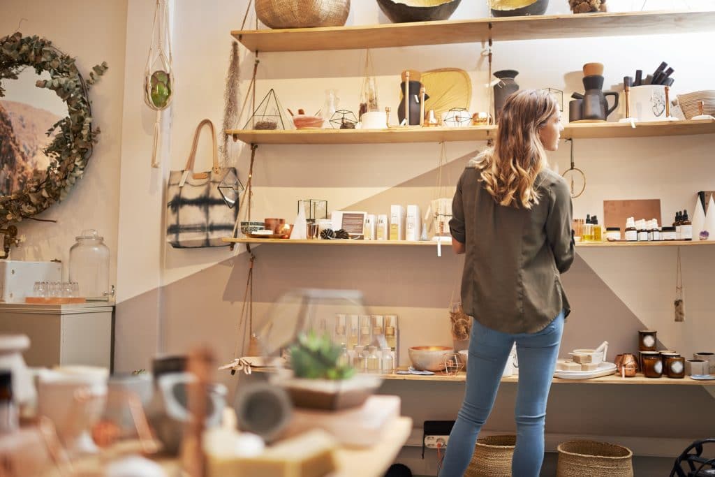 Female shopper browsing merchandise on the shelves of a boutique