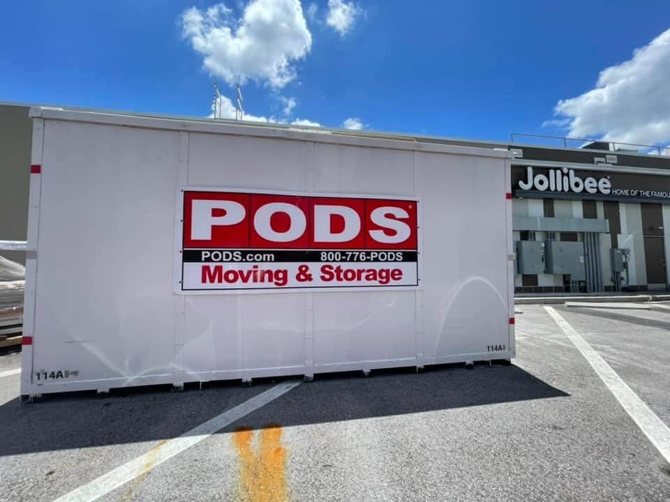A PODS commercial storage container in a Jollibee restaurant parking lot