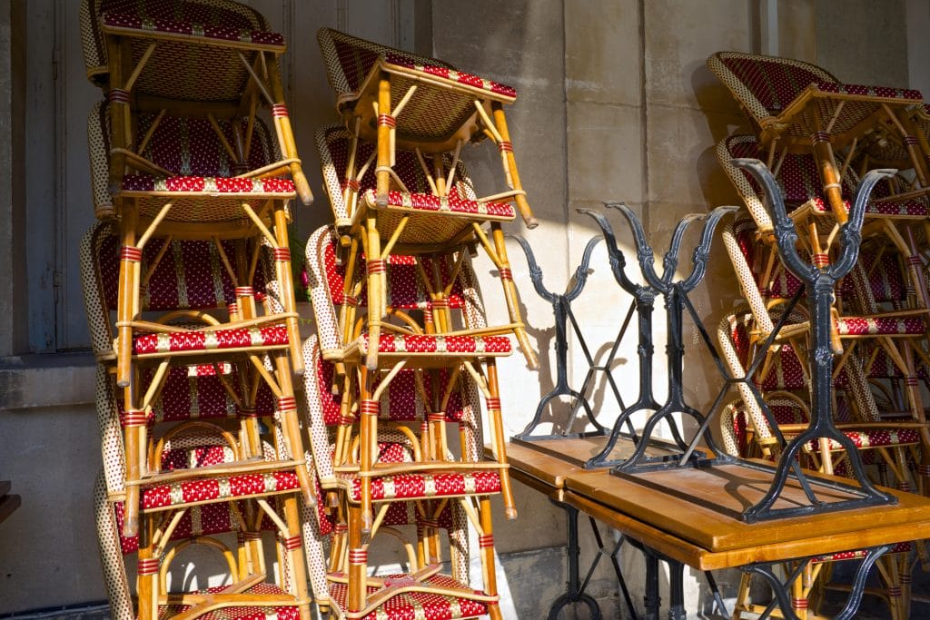 Bistro chairs stacked maybe because of a restaurant relocation move