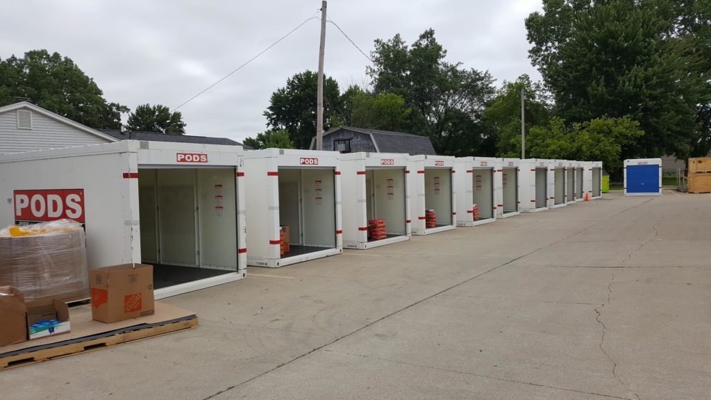 Row of empty open PODS containers sitting in a parking lot