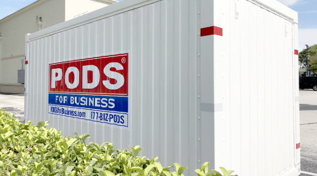 A PODS container sitting in a retail store parking lot