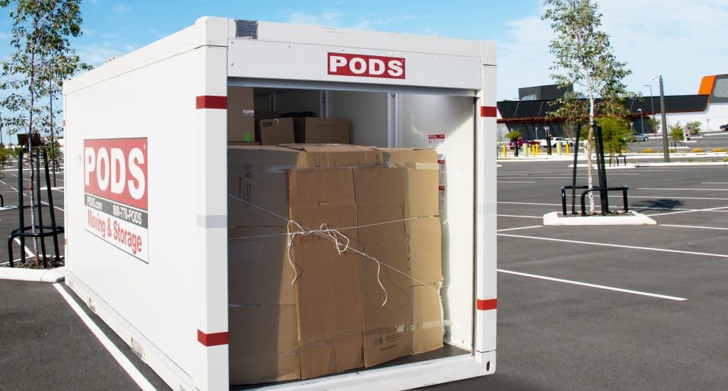 PODS container in a parking lot loaded with inventory for curbside pickup