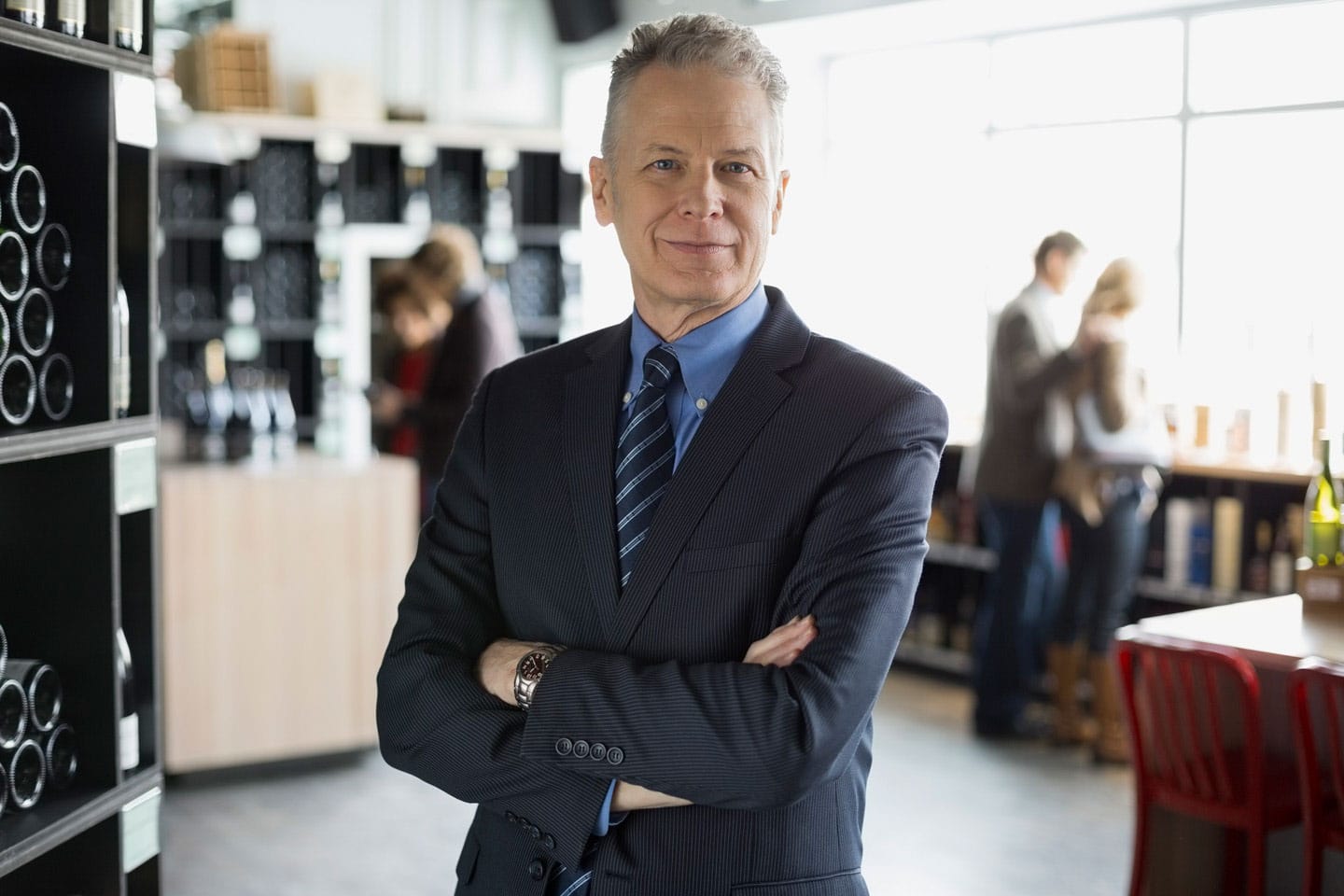 Male wine retail owner standing inside his store location