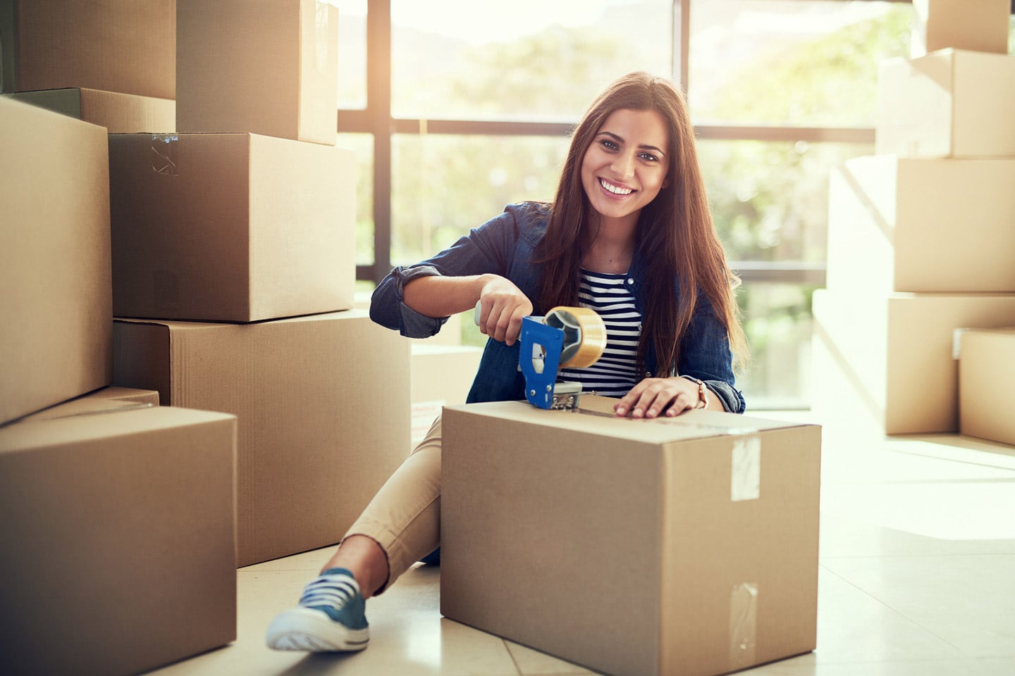 Woman packing boxes for a business relocation move
