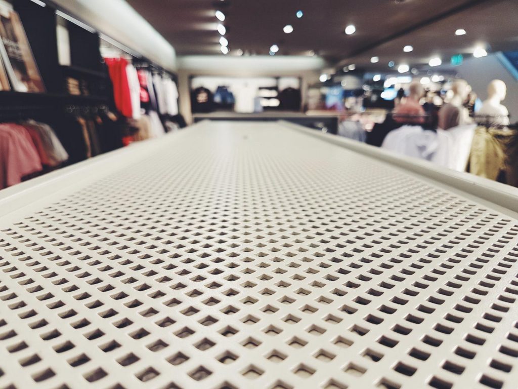 An empty shelf inside a clothing retail store