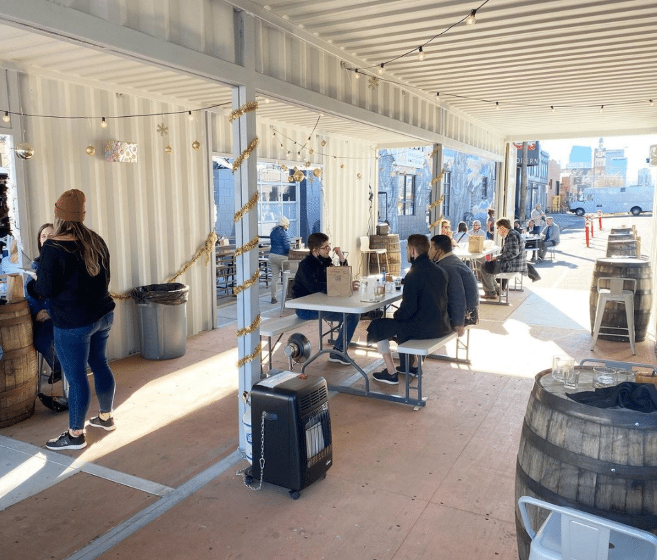 People dining inside a modified shipping contianer at a restaurant 