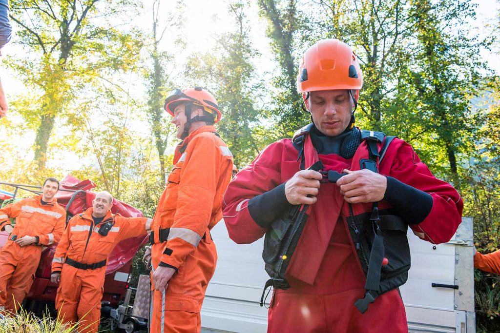 A disaster recovery volunteer putting on safety gear