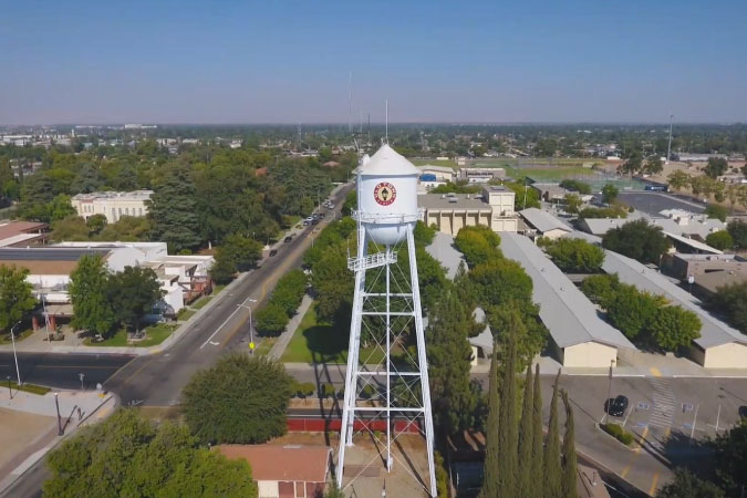 Aerial view of the city of Clovis, California, featuring a water tower