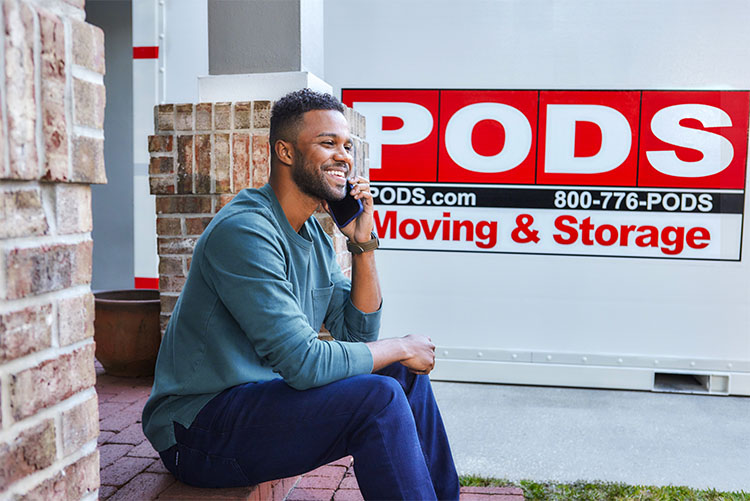A man calls PODS moving and storage to plan his move to a city near D.C. A PODS container sits in his driveway