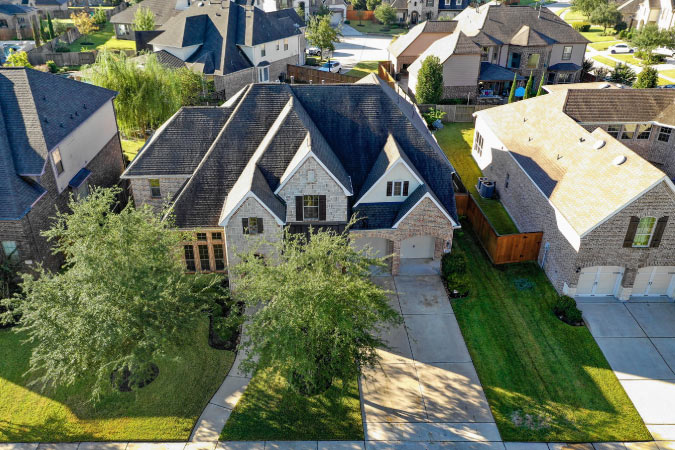Aerial view of several luxury homes in the Cypress, Texas, neighborhood of Towne Lake.