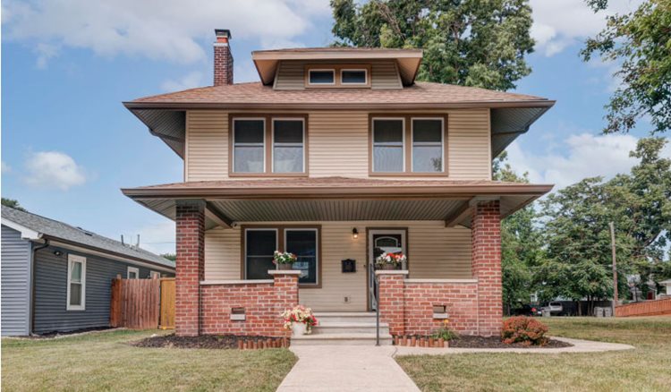 Streetside view of a two-story, American Foursquare-style house in Mapleton-Fall Creek — one of the best Indianapolis neighborhoods.