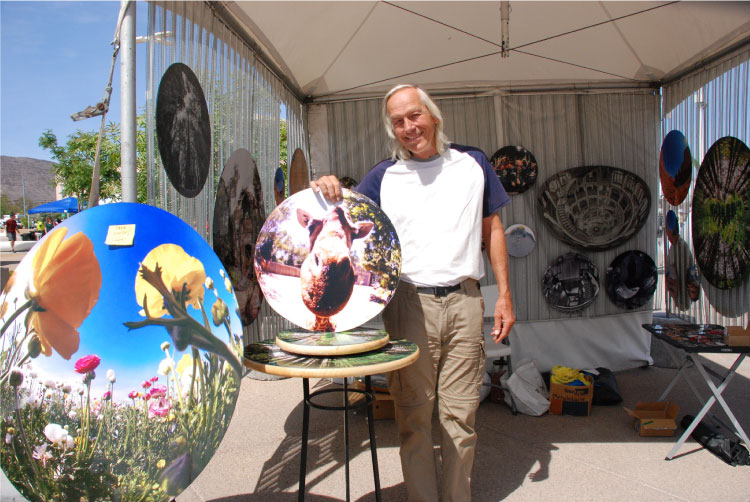 An artist poses with his art at the Art Festival of Henderson in the Water Street District of Henderson, Nevada.