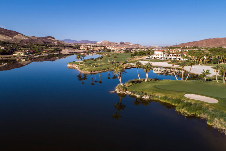 Aerial view of the Lake Las Vegas community in Henderson, Nevada. The community features Mediterranean-style architecture, a pristine lake, golf course, and panoramic views.