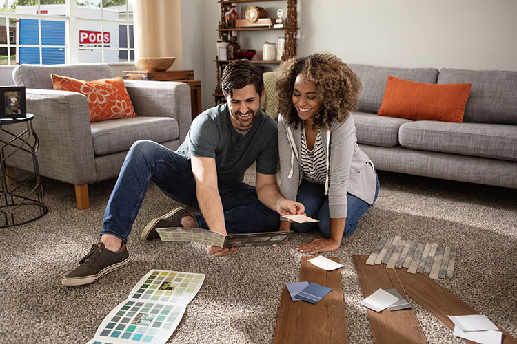 A young couple picks out color samples as they get ready for her renovation.