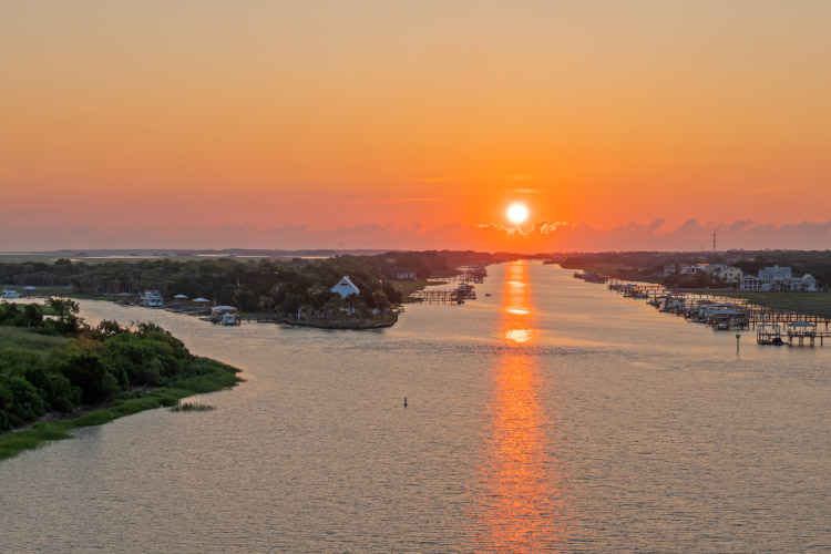 The sun rises above the Atlantic Intercoastal Waterway between the cities of Isle of Palms and  Mount Pleasant in South Carolina.