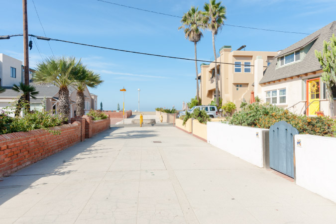 The view down a cute beachy residential street in Hermosa Beach, CA, one of the best Los Angeles suburbs.