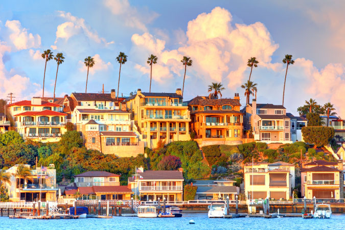 View from the water of luxurious oceanfront homes in Newport Beach, California.