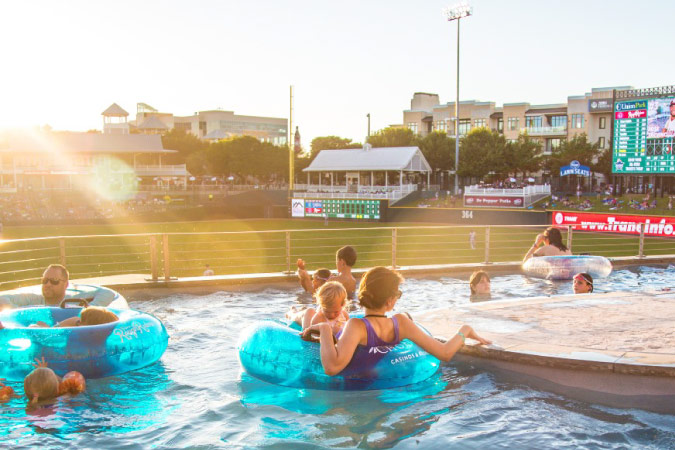 Locals take in the warm summer weather while relaxing in the lazy river at Riders Field in Frisco, Texas.
