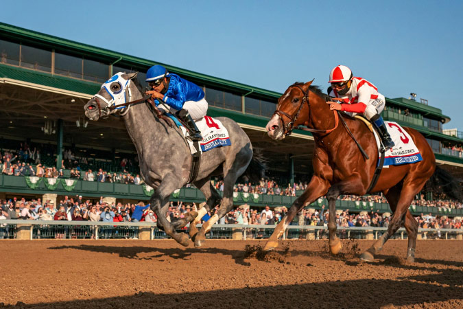Two jockeys race at the Keeneland horse track in Lexington, Kentucky.