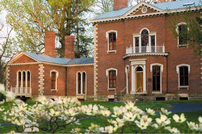 The impressive and historical Henry Clay estate in Lexington, Kentucky, featuring a red-brick exterior with white stone accents.