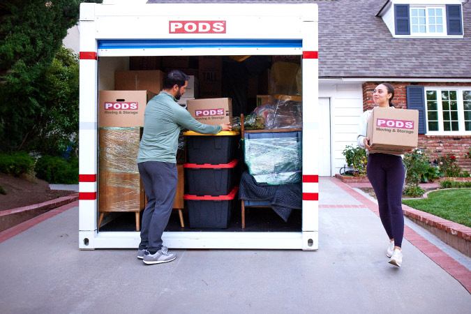 A couple is loading up the last of their belongings into a PODS portable storage container as they prepare to move to Lexington, Kentucky.