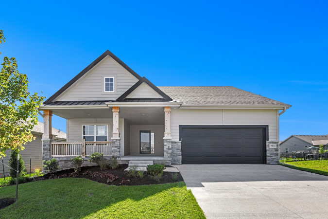 Exterior view of a one-story, single-family home in Omaha, Nebraska, featuring a two-car garage, covered front porch, and gabled roof. 