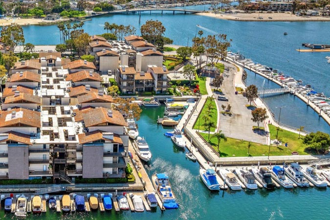 Aerial view of the Marina Pacifica neighborhood in Long Beach, California, featuring waterfront condos and private boat slips.