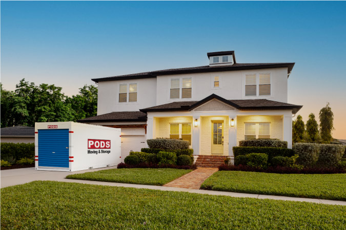 Exterior view of a modern home in Long Beach, California, with a PODS portable moving container parked in the driveway.