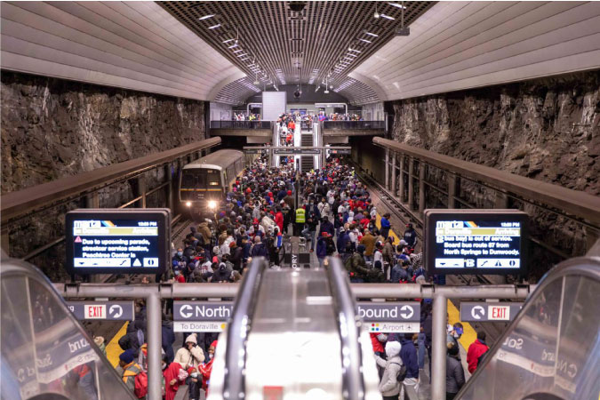 An underground platform is buzzing with dozens of locals waiting to board MARTA trains in Atlanta, Georgia.