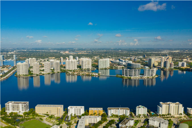Aerial view of the numerous high-rise condos along the waterfront in Aventura, Florida — a suburb of Miami.