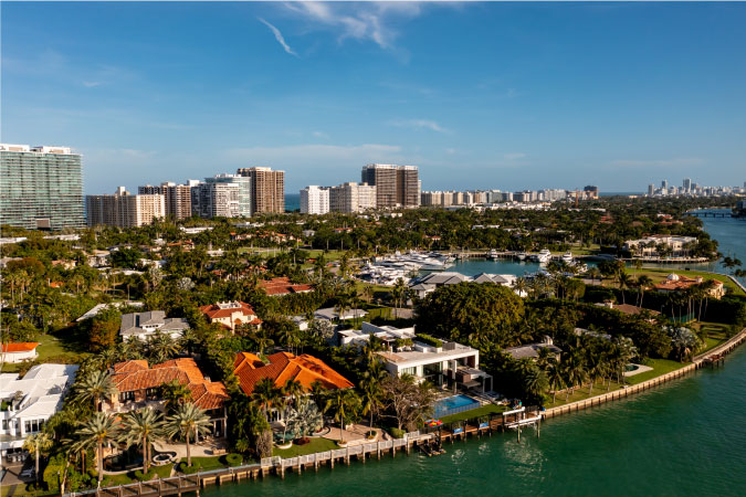 A residential neighborhood in the Miami suburb of Bal Harbour, Florida, featuring luxury waterfront mansions and private docks. 