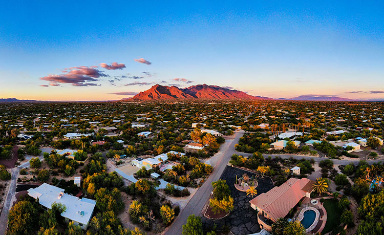 An aerial panoramic of a Tucson neighborhood with the San Catalina Mountain Range in the distance